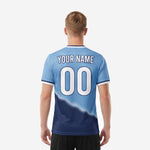 Close detail of powder blue to navy blue gradient sublimation print on custom men's soccer jersey showing color transition