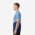 Custom blue and white soccer jersey right side view showing full-dye sublimation gradient and back name print zone on male model