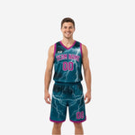 Custom printed reversible basketball uniforms in teal and magenta lightning pattern, front view showing team name and number 00 on the teal side with matching shorts