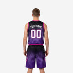 Opposite side view of purple and black sublimated basketball uniform set with shooting-star graphic detail on shorts lower leg