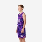 Side view of purple and pink camo youth basketball uniform showing V-neck binding, armhole trim, and shorts side split at the hem