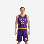 Custom purple and gold basketball uniforms front view showing V-neck jersey with gold side panels and arched team name above number 00 on matching purple shorts