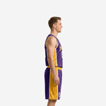 Side view of purple and gold basketball uniform set showing full-length gold side panel on jersey and shorts with white piping trim detail