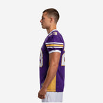 Left side view of custom purple and gold sublimated football jersey showing set-in sleeve construction and side panel width