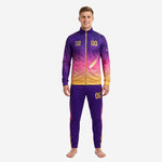 Adult male wearing a custom purple soccer tracksuit with Athletic Gold gradient and constellation print, front view