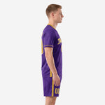 Side view of sublimated purple and gold soccer kit showing gold side stripe on jersey and shorts