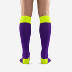Close detail of neon yellow ribbed cuff band on custom purple soccer socks for club teams