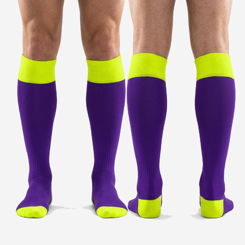 Full length pair of custom purple and gold soccer socks laid flat showing colorblock construction