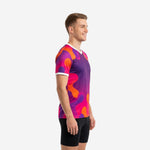 Custom purple soccer training shirt side view showing orange and hot pink splash pattern and white V-neck trim