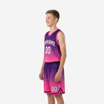 Second side view of custom purple pink youth basketball uniforms showing armhole binding and shorts waistband detail