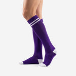 Custom purple soccer socks angled side view showing ribbed elastic cuff and full-length Royal Purple knit construction