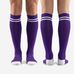 Custom purple soccer socks full-length standing view illustrating knee high fit over shin guard position