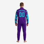 Close-up of custom purple soccer tracksuit chest showing turquoise team name, logo block, and player number sublimated print