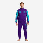 Custom purple soccer tracksuit with turquoise sublimated sleeves and slash-burst graphic, team name and number on chest, adult male model front view