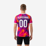 Close-up detail of full-dye sublimation splash print on custom purple soccer training shirt in orange, hot pink, and violet