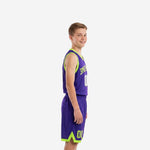 Front view of purple youth basketball uniform set with neon lime trim arched team name across chest and white number 00 on jersey and matching purple shorts