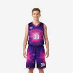Custom purple youth basketball uniforms with hot-pink galaxy burst print, arched team name on chest, matching shorts with double pink hem stripe, front and back view