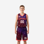Custom purple youth basketball uniforms in galaxy constellation print with coral trim, front view showing team name and number 00 on jersey and shorts