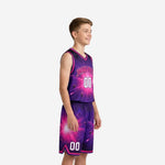 Front view of custom purple youth basketball uniforms showing V-neck with pink binding, arched team name, and white front number on galaxy sublimated jersey and shorts