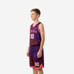 Reverse side view of purple galaxy youth basketball uniform set showing constellation line pattern on jersey and matching shorts