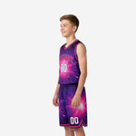 Right side view of custom purple youth basketball uniform set showing V-notch shorts hem detail and pink armhole binding on galaxy jersey