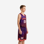 Side view of custom purple youth basketball uniforms showing galaxy gradient from violet to maroon and coral armhole binding detail