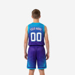 Second side view of purple youth basketball uniforms showing teal hem band and chevron detail at shorts leg opening