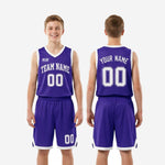 Close-up detail of purple basketball shorts with white elastic waistband, front number 00, and white V-notch accent at the leg hem