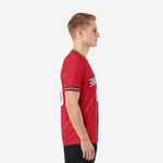 Custom red and black soccer jersey left side view showing short sleeve cuff trim and athletic cut on adult male model