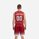 Side view of custom red and white basketball uniforms showing V-neck sleeveless jersey and matching crimson to white halftone-fade shorts on adult male model
