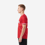 Custom red and white soccer jersey right side view showing sublimated red body and white contrast cuff trim on male model