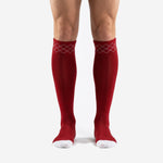 Custom red and white soccer socks with argyle cuff pattern shown from the front on a male model