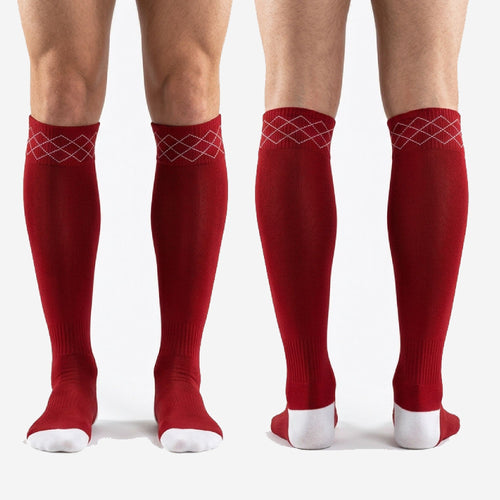 Full-length pair of custom red and white soccer socks laid flat showing argyle cuff and two-tone design