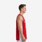 Front view of custom red basketball jersey showing arched YOURTEAM name in white block letters outlined in black above large number 23 on red chest panel