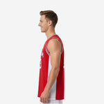 Side view of custom red sleeveless basketball jersey showing white side panel running full length from armhole to hem with red front and back panels