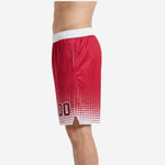 Close side panel detail of red and white sublimated basketball shorts showing dot pattern density increase toward the hem and internal drawcord waistband