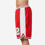 Opposite side view of custom red and black team basketball shorts showing white panel width and red-and-black hem stripe from hip to split