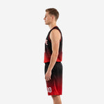 Left side view of red and black sublimated basketball uniform set showing armhole binding and gradient shorts with elastic waistband