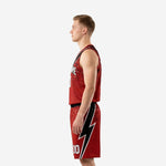 Left side view of custom red and black basketball uniforms showing dot texture on red jersey panels and matching shorts waistband