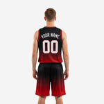 Right side view of custom red and black basketball uniform showing the smooth gradient fade from black shoulders to red hem on jersey and shorts