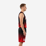 Side view of custom red and black basketball uniform set showing the full black-to-red gradient fade on the sleeveless jersey and matching shorts