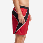 Custom red soccer shorts with diagonal black front panel and white piping, left side view on male model