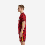 Mens custom red camo soccer uniform side view showing maroon V-neck collar and neon yellow side panel stripe detail