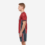 Custom crimson and charcoal soccer uniform right side view showing full-dye sublimated jersey and matching shorts on male model