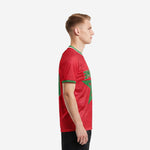 Custom red soccer shirt left side view showing Kelly Green star design and sleeve cuff trim, K2 Sportswear