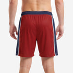 Back view of custom red and black soccer shorts with navy blue elastic waistband and white stripe side panels