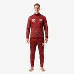 Men's custom red and black soccer tracksuit with dot-burst sublimation print, full-zip stand collar jacket and tapered pants, front view with team logo and number 00