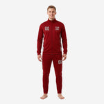 Custom red soccer tracksuit in maroon with silver hex side panels, front view on adult male model showing chest crest and number print zones