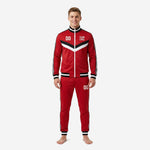 Mens custom red soccer tracksuit full zip jacket and tapered pants with black and white chevron chest panel and triple stripe sleeves front view