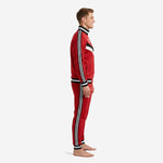 Custom red soccer tracksuit side view showing black and white triple stripe running full sleeve length and tapered pant leg